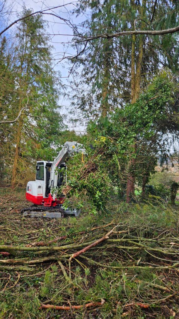 Takeuchi moving brash and stacking ready for chipping